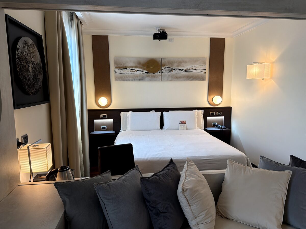 Overview of Cinema Room 210 with sofa, bed and projector